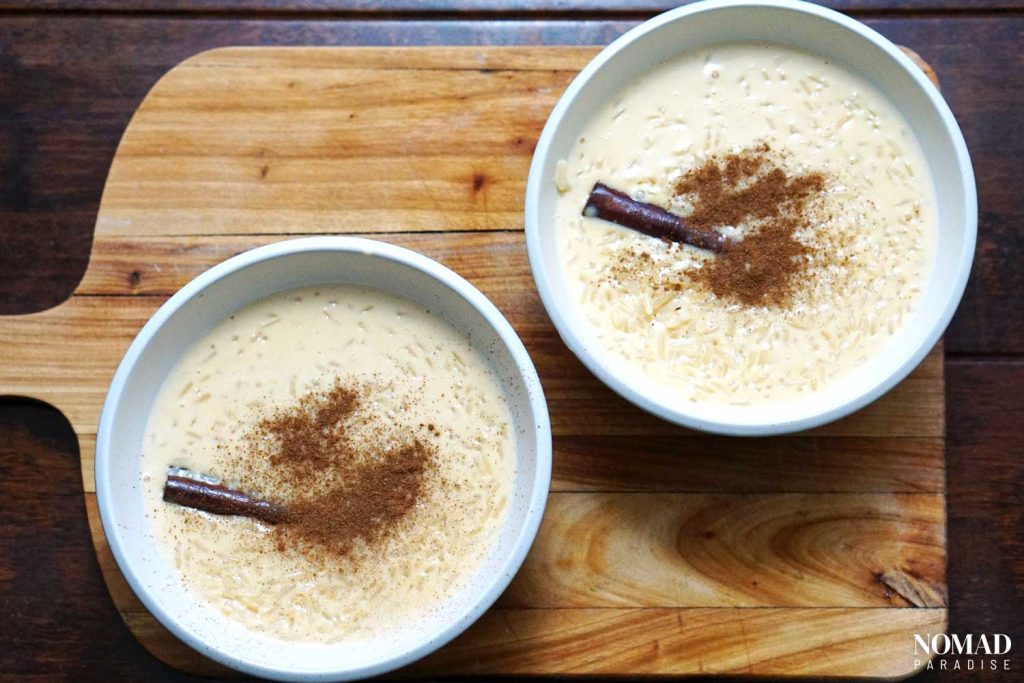 Arroz con leche in bowls with ground cinnamon on top.