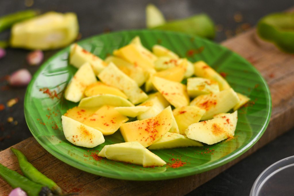 Sliced green mango with spices.