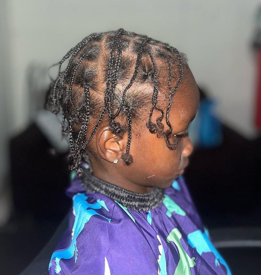 little boy with thin braids