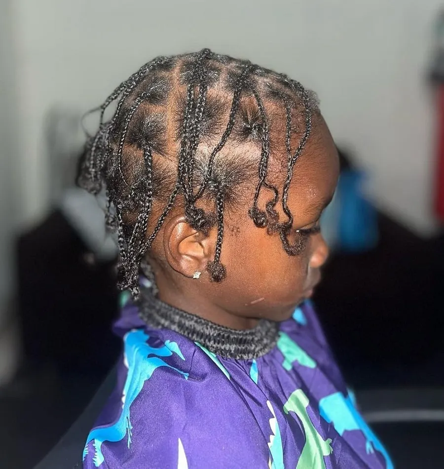 little boy with thin braids