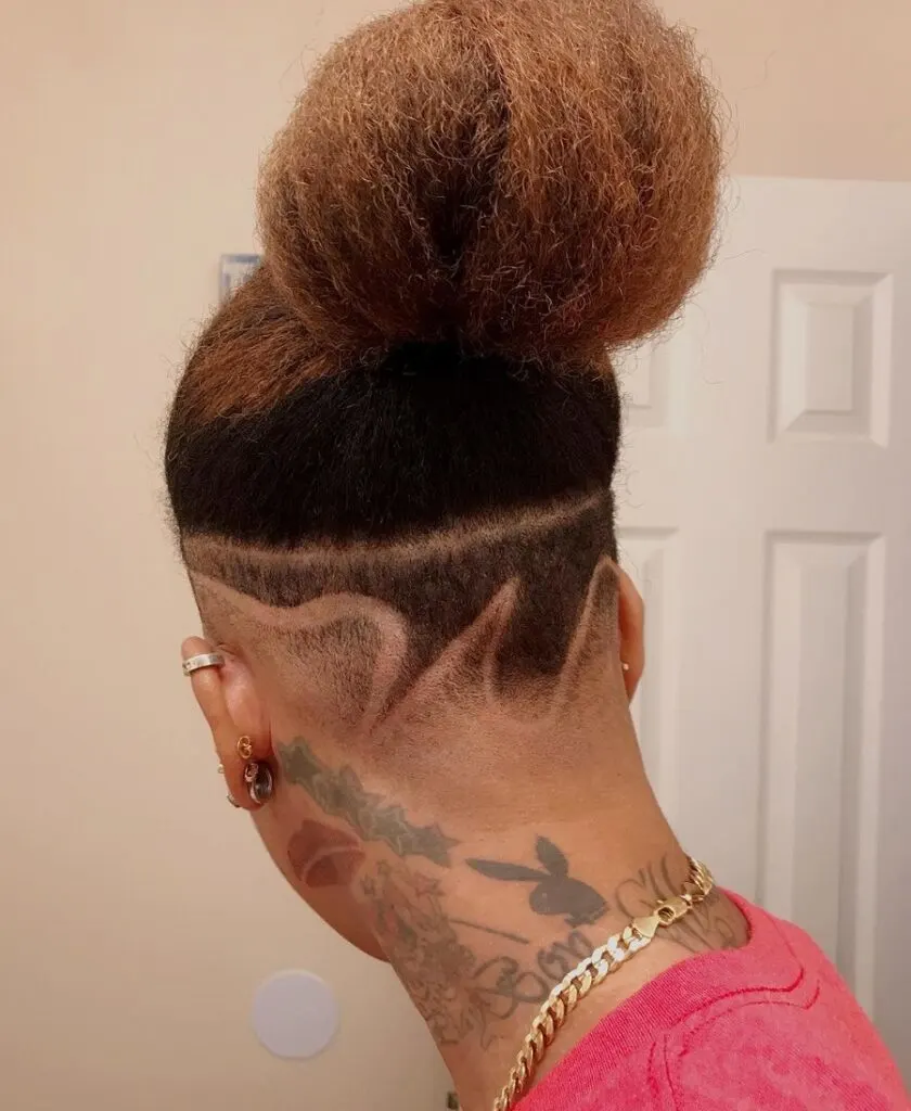 long hair man bun with fade and design