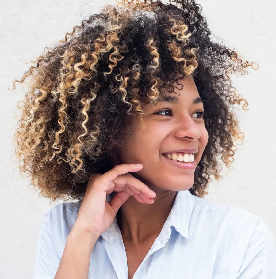 mixed girl curly hair with blonde highlights