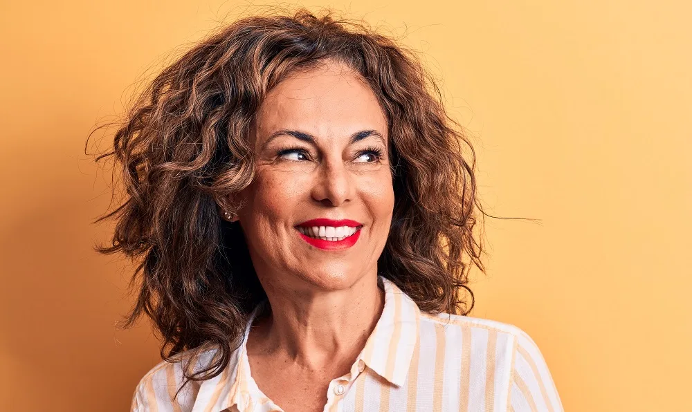 older woman with messy brunette hair